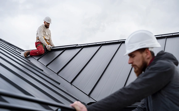 men working on new metal roof